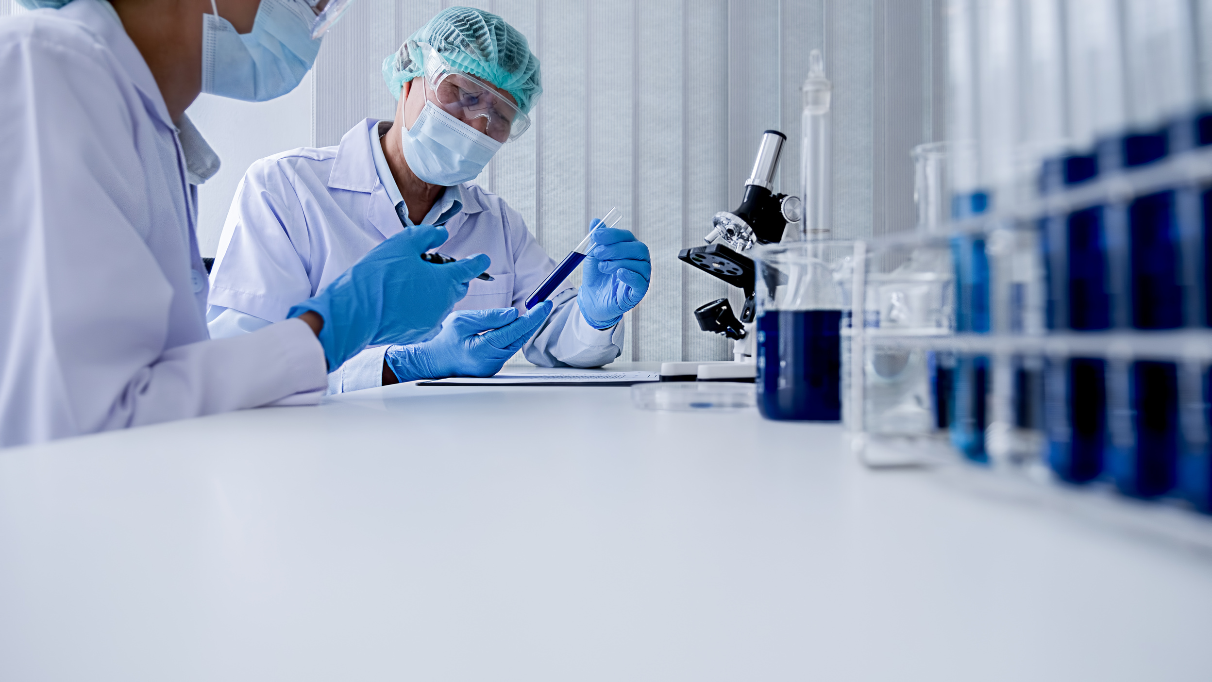 Scientific Researchers Looking at a Test Tube at the Lab
